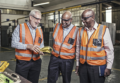 Acting Orica GM for Africa, Dallas Wilkinson, with Reindus founder Leven Moodley and a colleague, examining equipment